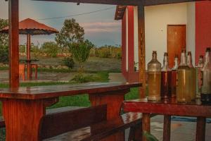 a bar with bottles of wine sitting on tables at Pousada Chalés Além do Paraíso in Alto Paraíso de Goiás