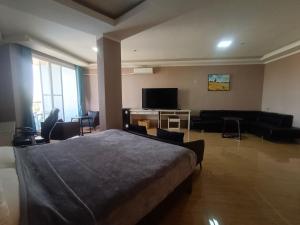 a bedroom with a bed and a living room at Blue Hotel and Resort in Porac