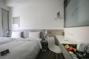 Letto o letti in una camera di CityInn Hotel Plus- Fuxing North Road Branch