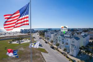 an aerial view of the beach with the american flag at Seas the Day home in Atlantic Beach