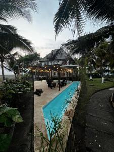 a resort with a swimming pool next to the ocean at Cabo tortugas - casa in Monterrico