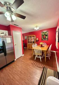 a kitchen and dining room with a table and a refrigerator at Family Friendly Downtown Home - Private Yard & Grill - Location, Location, Location! in Athens
