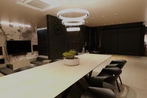 a conference room with a large white table and chairs at private villa クニウミ之チ in Awaji