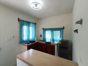 a kitchen with a sink and a refrigerator at LOFT VULKAY HOLBOX PBaja in Holbox Island