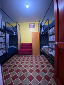 a room with two bunk beds and a staircase at Mundo Viajero Saphy in Cusco