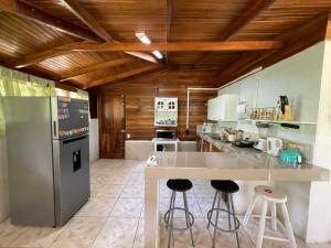 a kitchen with a counter and a refrigerator at Casa Lindamargarita 