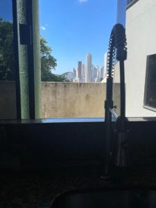 a hair dryer in a room with a view of a city at Colione House in Balneário Camboriú