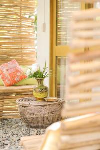 a vase with flowers on a table on a patio at The Living Room Siargao in General Luna