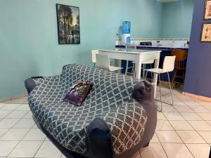 a bed with a pillow on top of it in a room at Horus Suite Apartamento in San Pedro Sula