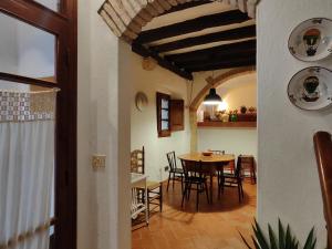 a kitchen and dining room with a table and chairs at Casa Castelló d'Empúries, 4 dormitorios, 8 personas - ES-228-96 in Castelló d'Empúries