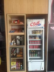 a toy refrigerator with its door open next to a shelf at Ibis Budget Makassar Airport in Makassar
