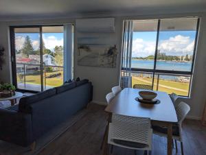 a living room with a couch and a table at Shoreline Unit 8 in Tuncurry
