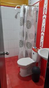 a bathroom with a toilet and a sink at Posada lucyta in Consacá +3 photos