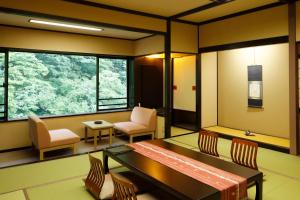 a room with a bench and chairs and windows at Hana to Hana in Nikko