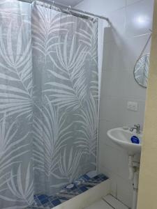 a shower curtain in a bathroom with a sink at Hotel Ocean View in San Juan del Sur