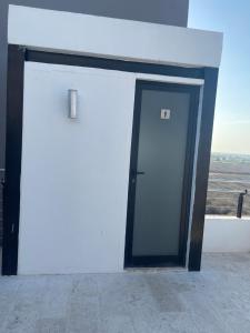 an open door to a building with a window at Departamento Torre Onze in Mérida +25 photos