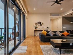 a living room with a couch and a table at Cosy Apartment at KL City Centre in Kuala Lumpur