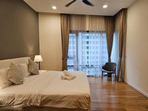 a bedroom with a bed with a ceiling fan at Cosy Apartment at KL City Centre in Kuala Lumpur