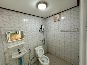 łazienka z toaletą i umywalką w obiekcie สวนสบายปลายนารีสอร์ท w mieście Ban Hin Lat