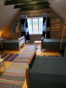 an attic room with a bed and a window at Saadumäe Holiday House in Saareküla