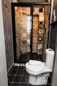 a bathroom with a toilet and a shower at Casa Columpio in Mexico City