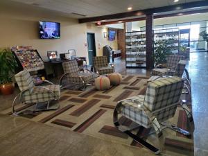 a waiting room with chairs and basketballs on a rug at Four Points by Sheraton Oklahoma City Airport in Oklahoma City
