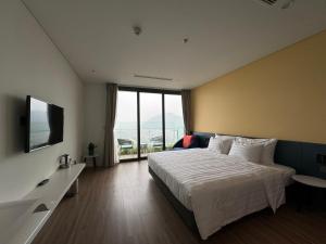 a hotel room with a bed and a television at Flamingo Ibiza Hải Tiến in Nam Khê