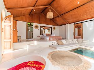 a large living room with a pool and a bedroom at BaraJade Villas in Uluwatu