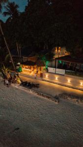 a building with lights on a beach at night at Morgan Villas in El Nido