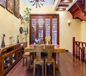 a dining room with a wooden table and chairs at Annie Dianchi Lake Villas in Kunming
