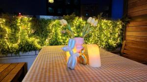 a table with a candle and a vase with flowers at Seoul COMOCASA Premium Terrace Residence in Seoul