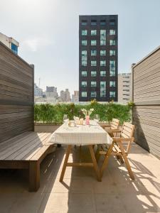 a table and chairs on the roof of a building at Seoul COMOCASA Premium Terrace Residence in Seoul