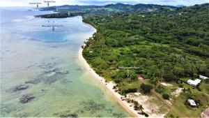 an aerial view of a beach and the ocean at Sigasiga Sands Boutique Bungalows in Savusavu