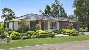 a house with a landscaping in front of it at 1oak - The Vintage in Pokolbin
