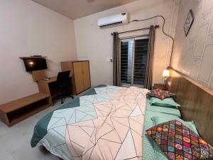 a bedroom with a bed and a desk at GREEN HOME STAY in Lucknow