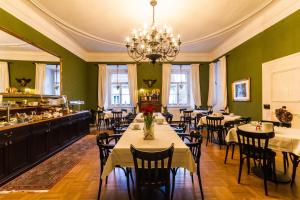 a dining room with tables and chairs and a chandelier at Boutique-Hotel Alter Gerichtshof in Hartberg