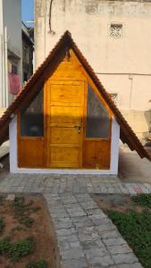 a wooden door with windows on a building at Starlit premium camps in Mahabalipuram