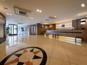 a lobby with a waiting area in a building at Keio Presso Inn Otemachi in Tokyo