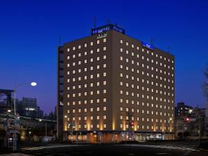 a tall building with lights on the top of it at Keio Presso Inn Otemachi in Tokyo