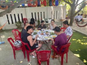 a group of people sitting around a table eating food at Hoa Bien Motel in Ly Son