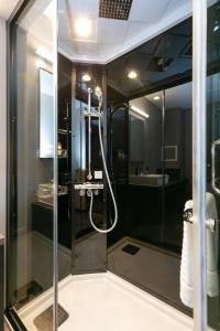 a shower with a glass door in a bathroom at HOTEL TABARD TOKYO in Tokyo