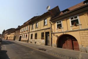 a row of buildings on the side of a street at Versus Art Studio in Braşov