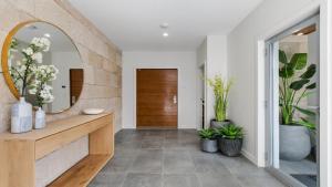 a bathroom with a mirror and a counter with plants at Hunter Valley Wildflower in Pokolbin