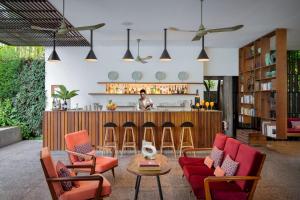 a living room with chairs and a bar at Viroth's Hotel in Siem Reap