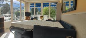 a bed in a room with a large window at Refuge Arago by Les Demeures de Rachel in Vernet-les-Bains