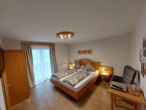 1 dormitorio con 1 cama y 1 silla en Wagnerhof, en Pichl bei Aussee