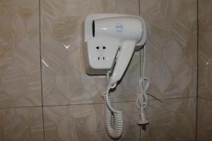a white phone is hanging on a wall at Horison Sentani in Sentani