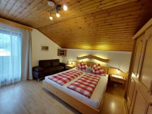 a bedroom with a large bed and a couch at Wagnerhof in Pichl bei Aussee