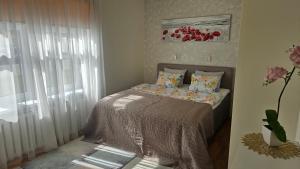 a small bedroom with a bed with a window at Unique & Spacious 2 Bedroom Apartment with Sauna in Pärnu