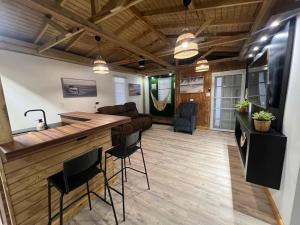 a kitchen and living room with a bar and chairs at VSS Beach House - Arecibo in Arecibo